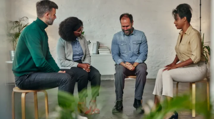 Persons from various therapy specialist collaborating in a meeting, discussing ideas and sharing expertise, representing the concept of interdisciplinary collaboration.