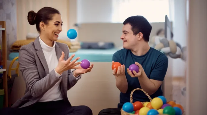 Therapist engaging in a supportive session with a neurodiverse client, using adaptive techniques to foster understanding and communication.