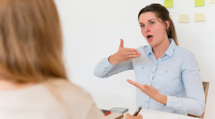 Speech therapist demonstrating vocal exercises to a patient for improving voice quality and treating vocal cord disorders.